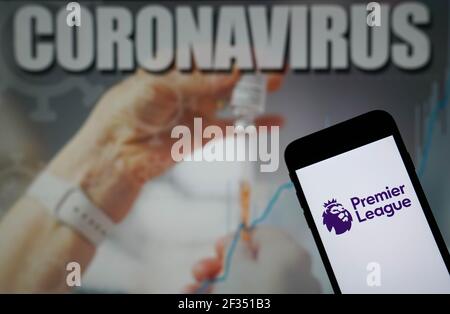 File photo dated 09-01-2021 of The Premier League logo seen displayed on a mobile phone with a Coronavirus illustration on a monitor in the background. Issue date: Monday March 15, 2021. Stock Photo