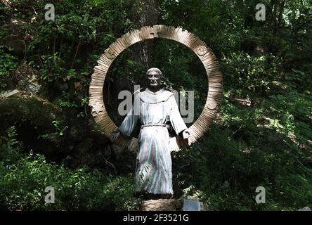 ASSISI, ITALY - JUNE 29, 2014: The statue of St. Francis of Universal Love (S. Francesco dell'Amore Universale) at Eremo dell Carceri made by Sandro D Stock Photo
