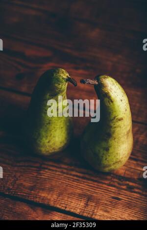Still Life with Two Green Pears on Wooden Table Stock Photo