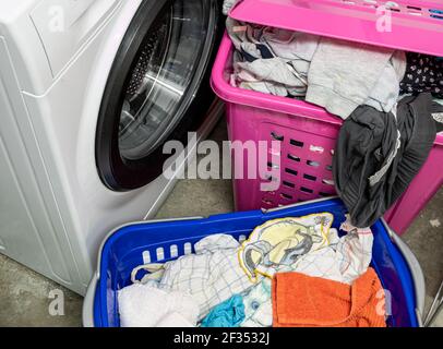 Laundry basket with laundry in the laundry room Stock Photo