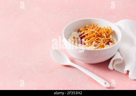 rice pudding with Norwegian brunost traditional brown cheese and raspberry jam Stock Photo