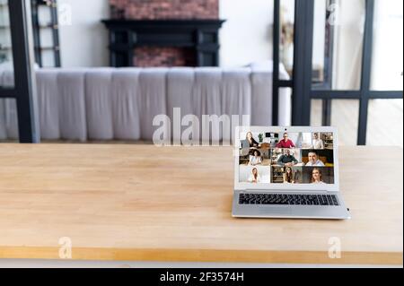 Many portraits faces of diverse young and aged people webcam view, laptop on the desk, empty space, while engaged in videoconference on-line meeting, group video call application easy usage concept Stock Photo
