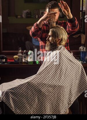 Annoy barber could turn out poorly for your ear. Donation and charity concept. Guy with dyed hair. Cut hair. Barber hairstyle barbershop. Hipster Stock Photo