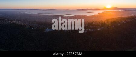 The last light of day illuminates San Francisco Bay and its surrounding cities and hills. This area is bordered by open space in the East Bay. Stock Photo