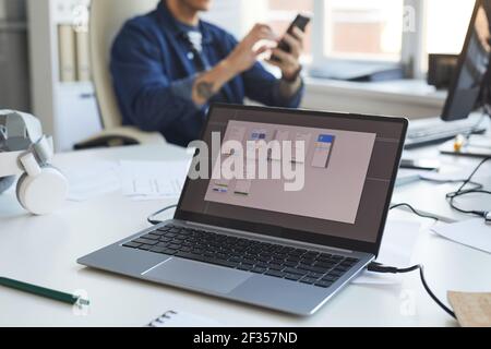 Close up of laptop screen with software design planning with IT development team in background, copy space Stock Photo