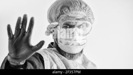 Dangerous zone. Stop. Personal protective equipment. Man wearing protective mask. Coronavirus pandemic. Garments protect health. Infection prevention Stock Photo