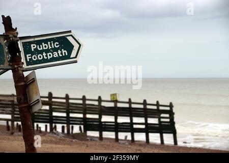 Public Footpath sign in Sussex pointing into the sea , England, UK Stock Photo