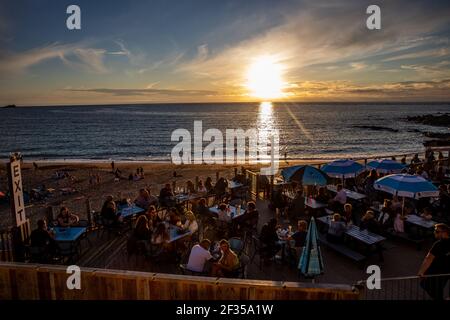 People enjoying themselves on Fistral Beach Bar in Newquay, Cornwall Stock Photo