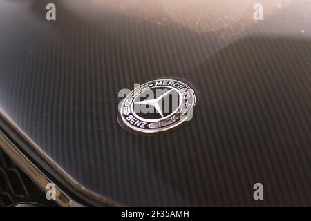 Mercedes Benz C63 AMG W204 Black Mercedes Benz Badge On An Aftermarket Carbon Fibre Mercedes Benz C63 AMG 507 Edition Bonnet Stock Photo