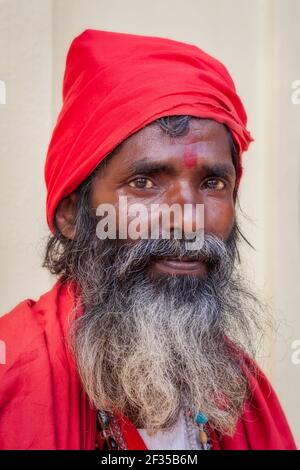Portrait of elderly sadhu dressed in red clothes, Kamakhya Temple, Guwahati, India Stock Photo