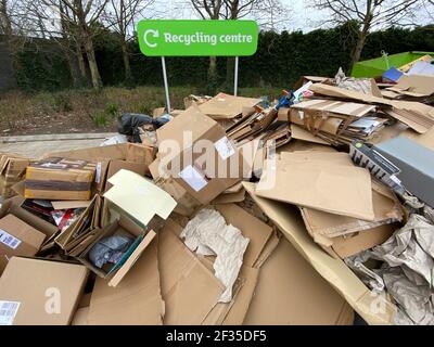 Cardboard boxes in front of a Recycling centre sign in a supermarket car park in south west London. Picture date: Sunday March 14, 2021. Stock Photo