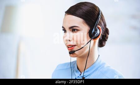 portrait of smiling call center operator in headset Stock Photo