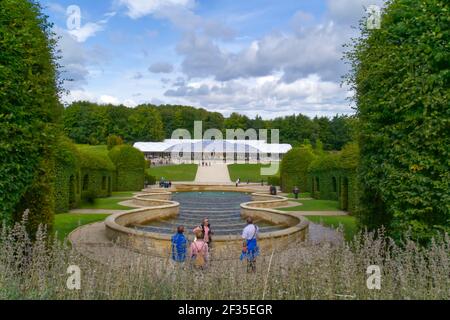 people admire the view of The Pavilion cafe from the top of the Grand cascade, Alnwick Garden is a popular visitor attraction, Alnwick, Northumberland Stock Photo