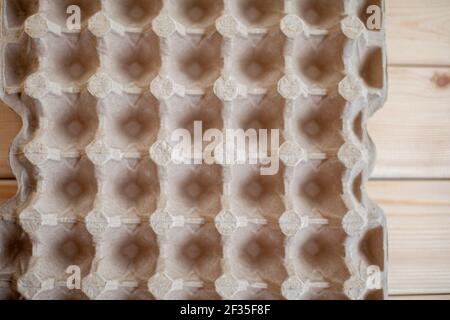 Protective cardboard packaging for storing eggs. Empty biodegradable molded egg box made of paper pulp. Stock Photo