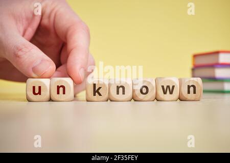 Know and unKnow Concept on Wooden Cubes. Stock Photo