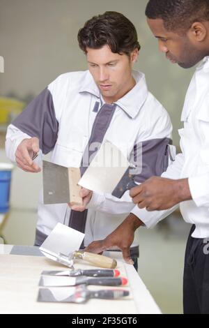 apprentice is learning to use a brush Stock Photo
