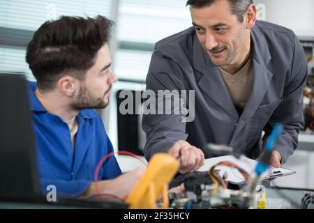 young apprentice electrician using multimeter Stock Photo