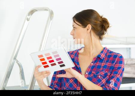 woman selecting home interior paint color from swatch Stock Photo