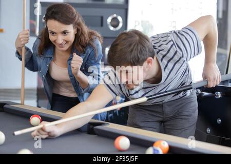 friends playing billiard man going hit a ball Stock Photo