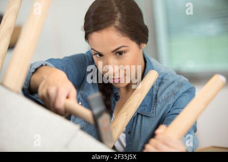 a woman working in upholstery workshop Stock Photo