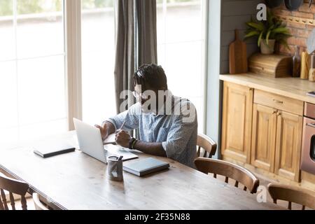 Confident black guy hold virtual business meeting online using laptop Stock Photo