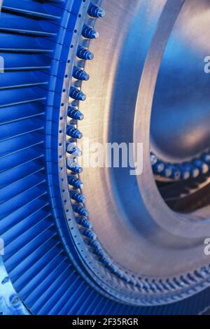 The rotor disk with the blades of a turbojet gas turbine engine with a blue glow. Elements, parts and mechanisms of turbines. Energy and mechanical en Stock Photo