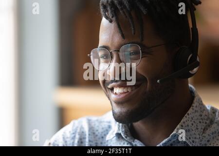Friendly black man call center operator in headphones contact client Stock Photo