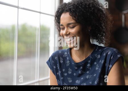 Millennial black woman laugh with closed eyes feel happy Stock Photo