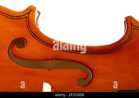 Close up macro of F hole on brown wooden fiddle or violin, classic musical instrument, isolated on white background, selective focus Stock Photo