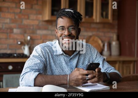 Portrait of successful black male modern day student holding smartphone Stock Photo