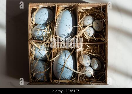 Easter background with Easter eggs in box with the hay, Easter card with copy space for text. Stock Photo