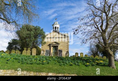 Spring daffodils in front of St Peter and St Pauls church Cherry Willingham Stock Photo