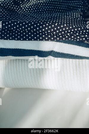 stack of woman clothes from white to dark with dotted and striped patterns Stock Photo