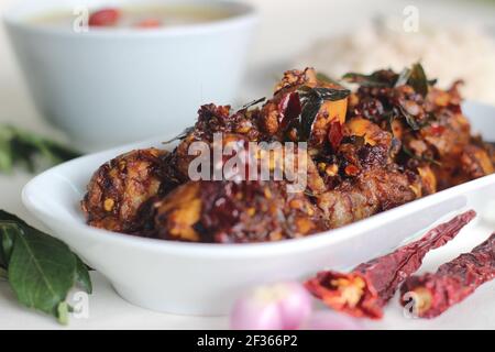 Homemade Chicken chilli prepared in desi style with 5 ingredients. A simple chicken recipe with whole red chillies, shallots, curry leaves, coconut oi Stock Photo