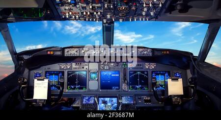 Cockpit pilot Flight Deck display. Throttle jet cabin with control panel plane. View in windows blue sky clouds Stock Photo