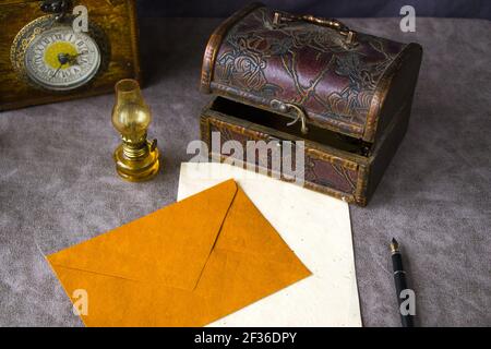 The vintage objects on the table, old box, lamp, clock, envelope, and pen Stock Photo