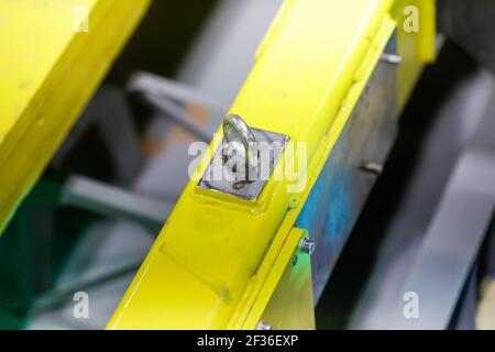 Shallow depth of field (selective focus) image with details of industrial metallic nuts and bolts in a heavy factory. Stock Photo