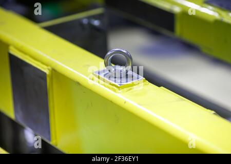 Shallow depth of field (selective focus) image with details of industrial metallic nuts and bolts in a heavy factory. Stock Photo