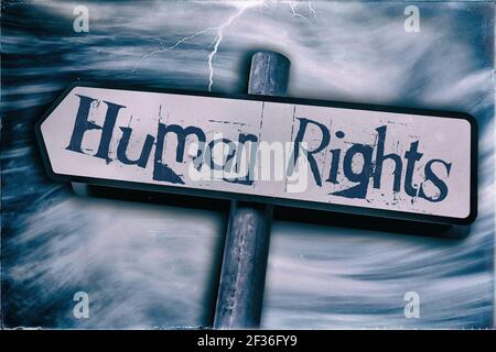 Human Rights displayed on a Sign post with a  Storm in the background Stock Photo