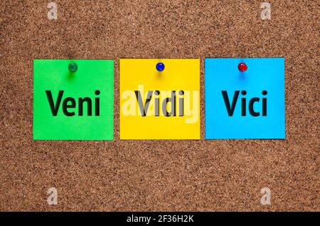 Three colored notes on corkboard with words Veni, vidi, vici (I came; I saw; I conquered) Stock Photo