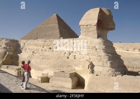 Cairo Egypt Egyptian Giza District Sphinx,face of Pharaoh Khephren lion body,visitors man woman female couple looking, Stock Photo
