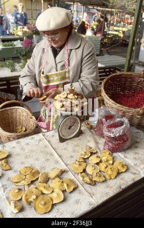 Tallinn Estonia woman female mushroom vendor selling stall market marketplace scale, Stock Photo