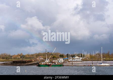 Riverbank, boats moorings and quay of North Fambridge on the River Crouch, looking from South Fambridge, Rochford, Essex, UK Stock Photo