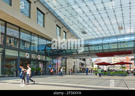 Mannheim, Germany - July 2019: Entrance of big modern shopping center called 'Q6 Q7' with people in Mannheim city center Stock Photo