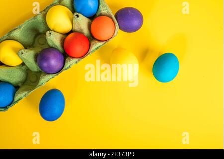 Multi-colored Easter eggs in an egg tray. Minimal concept Stock Photo