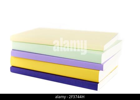 Colored books with blank spine stacked, isolated on a white background. Concepts of reading and education. Stock Photo