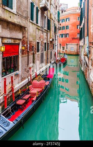 Gondolas with tourists sail on a canal in Venice, Veneto, Italy Stock Photo