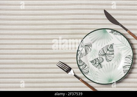 Beautiful flat lay arrangement with plate and cutlery. Festive table setting. Stock Photo