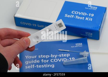 Covid-19 self-testing NHS test and trace home kit showing test results, this kit is given to school and college students for twice weekly testing. Stock Photo