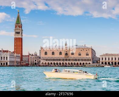 Doge's Palace and Campanile in Piazza San Marco and a speedboat taxi in Venice in Veneto, Italy Stock Photo